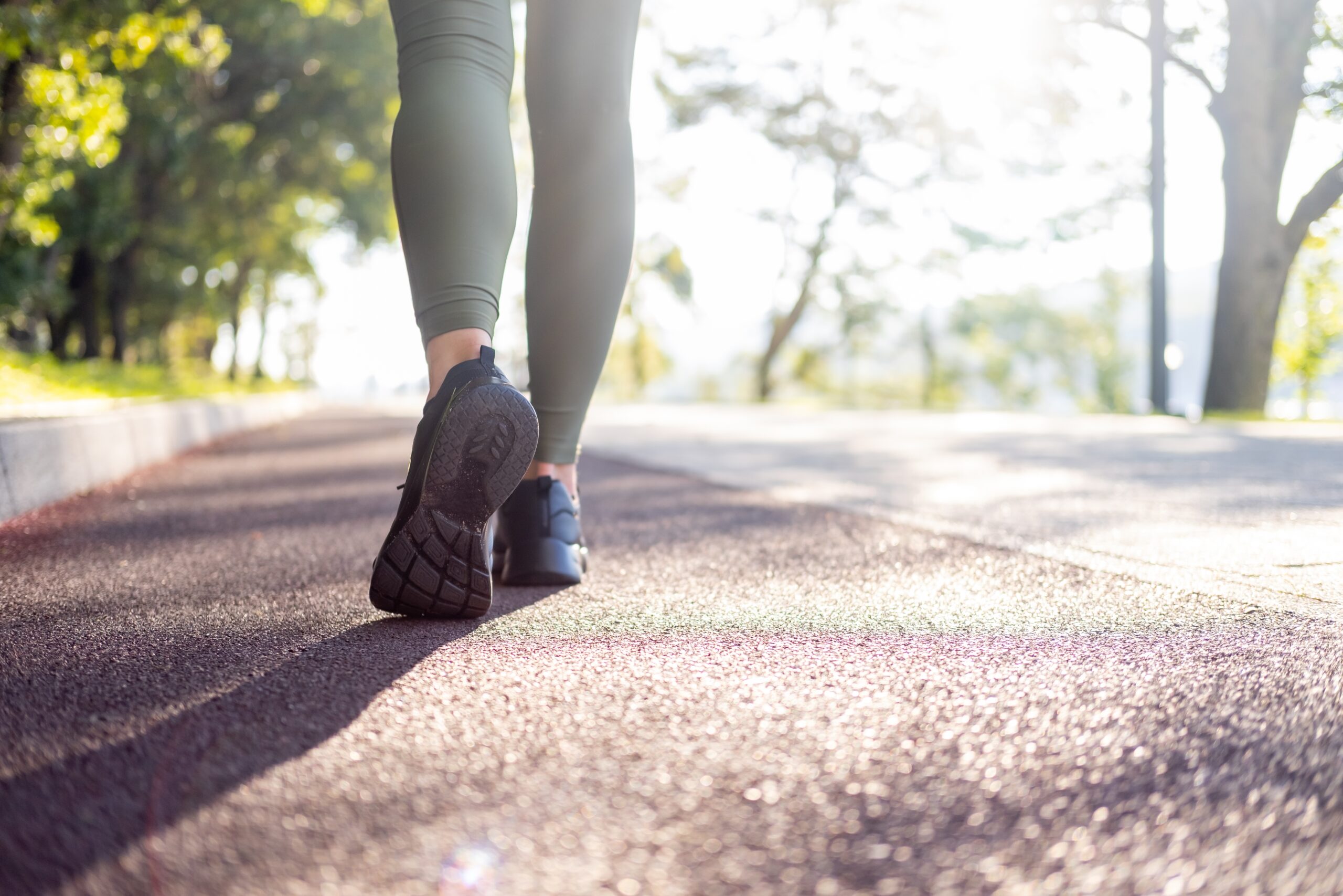 woman walking outdoors as part of a longevity lifestyle and daily wellness routine