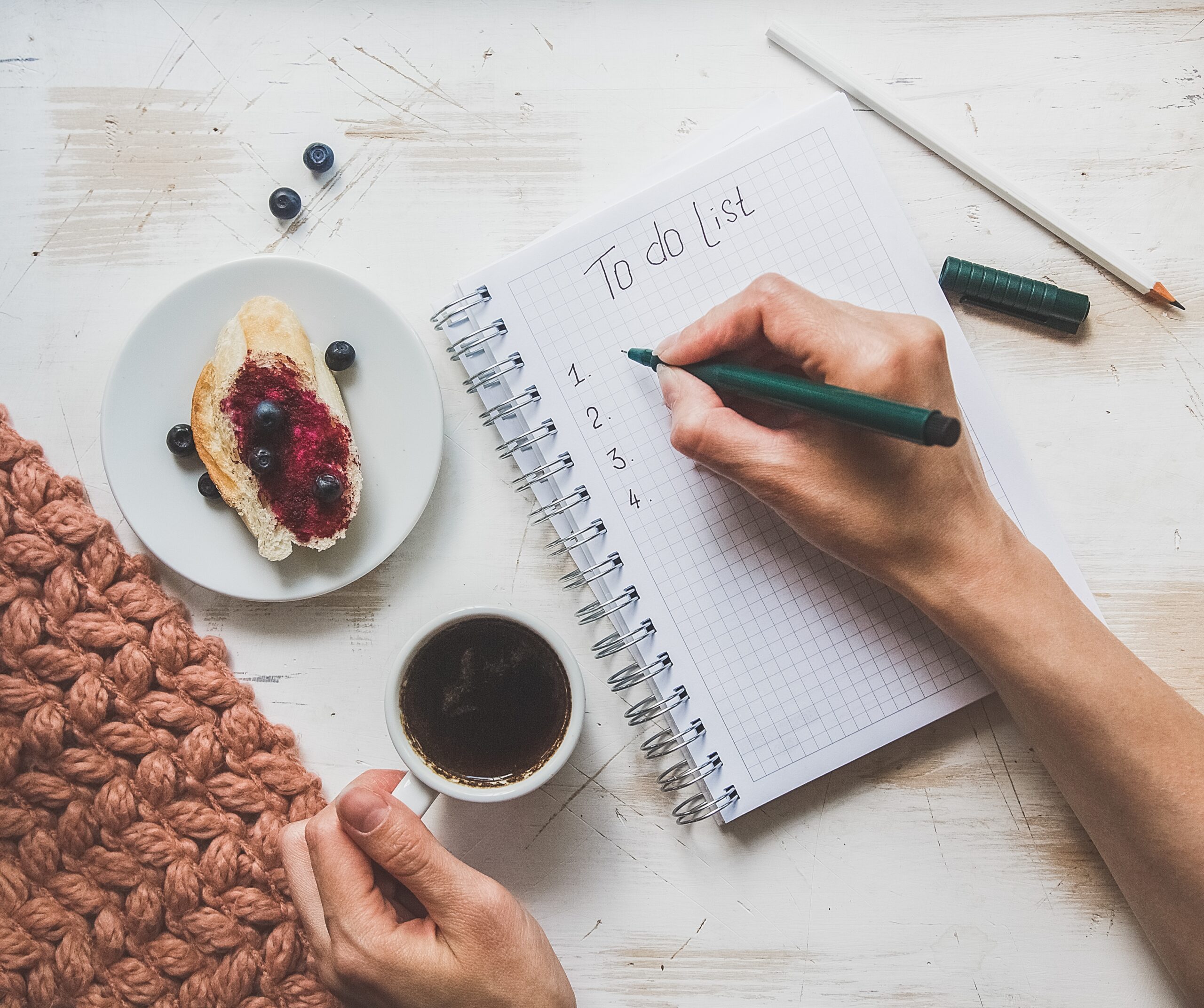Minimalist to-do list on notebook with coffee showing intentional productivity and simple daily planning